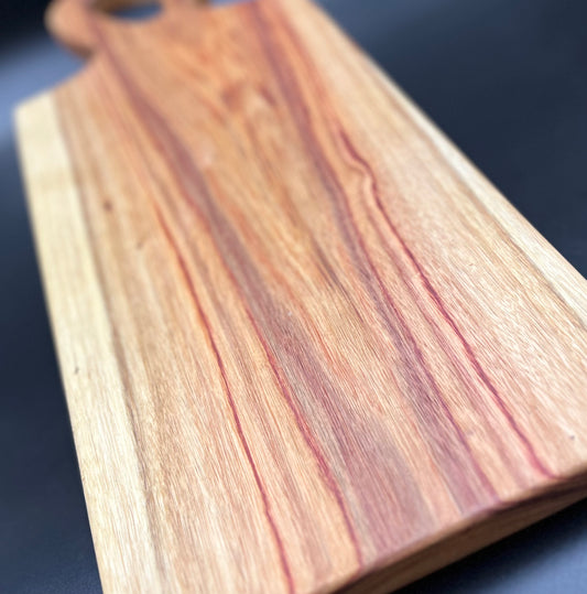 Beautiful Canary Wood Charcuterie board with striking reds, browns, and yellows